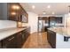 Spacious kitchen featuring stainless steel appliances, granite countertops, and dark wood cabinetry at 10315 Turia Gardens Rd, Las Vegas, NV 89135