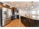 Gourmet kitchen featuring an island with a sink, stainless steel appliances, and granite countertops at 10315 Turia Gardens Rd, Las Vegas, NV 89135