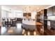 Open kitchen featuring an island, dark wood cabinets, stainless steel appliances, and dining area at 10315 Turia Gardens Rd, Las Vegas, NV 89135