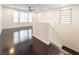 Spacious loft with dark wood floors, ceiling fan, and bright natural light at 10315 Turia Gardens Rd, Las Vegas, NV 89135