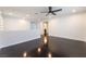 Open-concept loft with a neutral color palette, ceiling fan, and wood flooring at 10315 Turia Gardens Rd, Las Vegas, NV 89135
