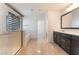Bright bathroom featuring dual vanity, shower and separate soaking tub at 10315 Turia Gardens Rd, Las Vegas, NV 89135