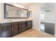 Bright main bathroom featuring dual sink vanity, dark cabinets and modern fixtures at 10315 Turia Gardens Rd, Las Vegas, NV 89135