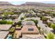 Suburban aerial view of homes with desert landscaping and solar panels, with mountains in the background at 10315 Turia Gardens Rd, Las Vegas, NV 89135