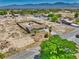 Expansive aerial view of a fenced property in Nevada featuring mountain views and desert landscaping at 1190 W Sierra Vista Cir, Pahrump, NV 89060
