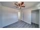 Bedroom featuring gray wood-look flooring, ceiling fan, and closet for ample storage space at 1190 W Sierra Vista Cir, Pahrump, NV 89060