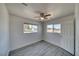 Bedroom featuring gray wood-look flooring and natural light from windows at 1190 W Sierra Vista Cir, Pahrump, NV 89060