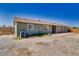Exterior view of single-story home with a neutral color, and spacious backyard at 1190 W Sierra Vista Cir, Pahrump, NV 89060