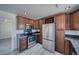 Kitchen with stainless appliances, granite counters and warm wood cabinets at 1190 W Sierra Vista Cir, Pahrump, NV 89060