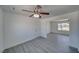 Bright living room features gray wood-look flooring, ceiling fan, and light-colored walls at 1190 W Sierra Vista Cir, Pahrump, NV 89060