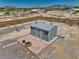 Aerial view of storage shed with surrounding hardscape and fire pit at 1190 W Sierra Vista Cir, Pahrump, NV 89060