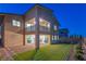 Backyard view with patio, grass lawn, sliding doors and second story balcony at 12367 Aster Hills Ave, Las Vegas, NV 89138