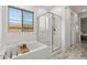Modern bathroom features a glass shower, soaking tub, and marble floors for a spa-like experience at 12367 Aster Hills Ave, Las Vegas, NV 89138