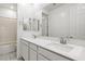 Bathroom featuring a double sink vanity with a large mirror and sleek hardware at 12367 Aster Hills Ave, Las Vegas, NV 89138