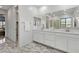 Bathroom with marble floors, and sinks and vanity with a view of the shower at 12367 Aster Hills Ave, Las Vegas, NV 89138