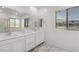 Modern bathroom with marble floors, double vanity, and natural light is perfect for starting your day right at 12367 Aster Hills Ave, Las Vegas, NV 89138