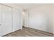 Bedroom with neutral paint, plank flooring, and large closet doors at 12367 Aster Hills Ave, Las Vegas, NV 89138