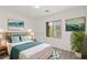 Relaxing bedroom with wood floors, stylish decor, cozy bed, and lush greenery for a peaceful retreat at 12367 Aster Hills Ave, Las Vegas, NV 89138
