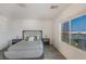 This cozy bedroom boasts a large window with an amazing city view, wood floors and a neutral color scheme at 12367 Aster Hills Ave, Las Vegas, NV 89138