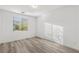 Clean, sunlit bedroom with wood-look floors and a neutral color palette at 12367 Aster Hills Ave, Las Vegas, NV 89138