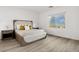 Bright bedroom with a big window view, wood floor, modern decor and a large bed for comfort at 12367 Aster Hills Ave, Las Vegas, NV 89138