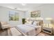 Bright bedroom featuring a plush bed with white bedding and a decorative palm tree print at 12367 Aster Hills Ave, Las Vegas, NV 89138