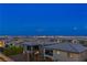 Las Vegas city view from the backyard featuring modern homes and balconies at dusk with clear sky for relaxing evenings at 12367 Aster Hills Ave, Las Vegas, NV 89138