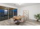 Modern dining area with natural wood table and seating, with access to the backyard at 12367 Aster Hills Ave, Las Vegas, NV 89138