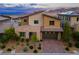 Contemporary two-story home featuring a brick driveway, desert landscaping, and mountain views at 12367 Aster Hills Ave, Las Vegas, NV 89138