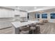Bright, white kitchen with quartz countertops, stainless steel appliances, and an oversized island at 12367 Aster Hills Ave, Las Vegas, NV 89138