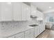 Gourmet kitchen featuring white cabinets, tile backsplash, and modern gas range at 12367 Aster Hills Ave, Las Vegas, NV 89138