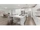 Bright kitchen with white cabinetry, quartz countertops, and island seating at 12367 Aster Hills Ave, Las Vegas, NV 89138