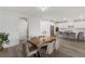 Open concept kitchen and dining area with white cabinetry and stainless steel appliances at 12367 Aster Hills Ave, Las Vegas, NV 89138