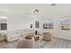 Inviting living room offers neutral tones, modern furnishings, large windows, and wood-look floors at 12367 Aster Hills Ave, Las Vegas, NV 89138