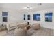 Cozy living room with plush seating, large windows, and neutral decor at 12367 Aster Hills Ave, Las Vegas, NV 89138