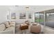 Comfortable living room features large windows with views, access to the patio, and neutral furnishings at 12367 Aster Hills Ave, Las Vegas, NV 89138