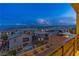 Balcony view of houses, mountains, and swimming pool under a twilight sky at 12367 Aster Hills Ave, Las Vegas, NV 89138