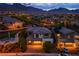 Beautiful aerial view of a desert home with stunning city and mountain views at twilight at 12404 Aster Hills Ave, Las Vegas, NV 89138