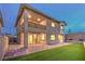 Spacious backyard featuring a covered patio, synthetic grass, and a private outdoor living space at 12404 Aster Hills Ave, Las Vegas, NV 89138