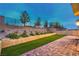 A multilevel backyard features artificial turf, brick pavers, a retaining wall and mountain views at 12404 Aster Hills Ave, Las Vegas, NV 89138