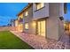 A two-story home's backyard boasts a manicured lawn and brick patio, perfect for outdoor entertaining at 12404 Aster Hills Ave, Las Vegas, NV 89138