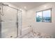 Bathroom featuring a walk-in shower, soaking tub, and marble floors near the window at 12404 Aster Hills Ave, Las Vegas, NV 89138