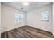 Well-lit bedroom featuring sleek wood-look floors and ample natural light at 12404 Aster Hills Ave, Las Vegas, NV 89138
