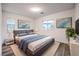 Stylishly furnished bedroom with a comfortable bed, modern decor, and natural light at 12404 Aster Hills Ave, Las Vegas, NV 89138