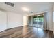 A spacious bedroom with wood flooring and sliding glass doors to a patio at 12404 Aster Hills Ave, Las Vegas, NV 89138