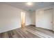 A bright, empty bedroom showcasing a closet and light, wooden-look floors at 12404 Aster Hills Ave, Las Vegas, NV 89138