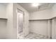 Walk-in closet with rods and shelves providing ample storage space, plus tile floors at 12404 Aster Hills Ave, Las Vegas, NV 89138