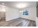 A bright empty dining room with an open pantry, fresh paint, modern lighting, and sleek floors at 12404 Aster Hills Ave, Las Vegas, NV 89138