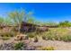 Welcoming Graycliff community entrance with lush landscaping and stone signage on a bright, sunny day at 12404 Aster Hills Ave, Las Vegas, NV 89138