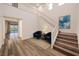 Bright, two-story foyer features hardwood floors, staircase, and a sitting area with modern decor at 12404 Aster Hills Ave, Las Vegas, NV 89138